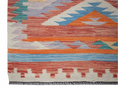 Handwoven Afghan Maimana kilim runner featuring a geometric pattern in vibrant orange and blue.