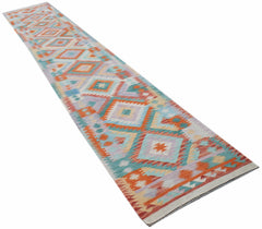 A long, handmade Afghan Maimana kilim runner featuring a colorful geometric diamond pattern.