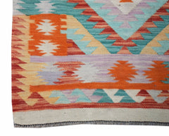 Handwoven Afghan Maimana kilim runner featuring a vibrant geometric pattern in wool.