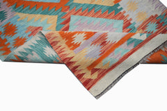A handmade Afghan Maimana wool kilim runner featuring a vibrant geometric pattern.