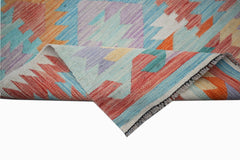 A handwoven Afghan Maimana wool kilim runner featuring a colorful geometric pattern.