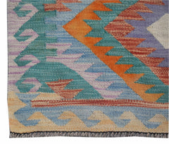 Handwoven Afghan Maimana kilim runner featuring a vibrant geometric pattern in wool.