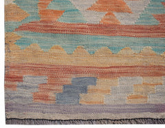 Handwoven Afghan Maimana wool runner featuring a geometric pattern in soft, muted earth tones.
