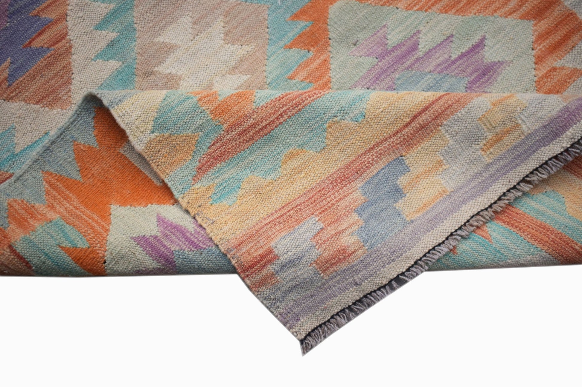 A handmade Afghan Maimana kilim runner featuring a geometric pattern in orange, blue, and purple.
