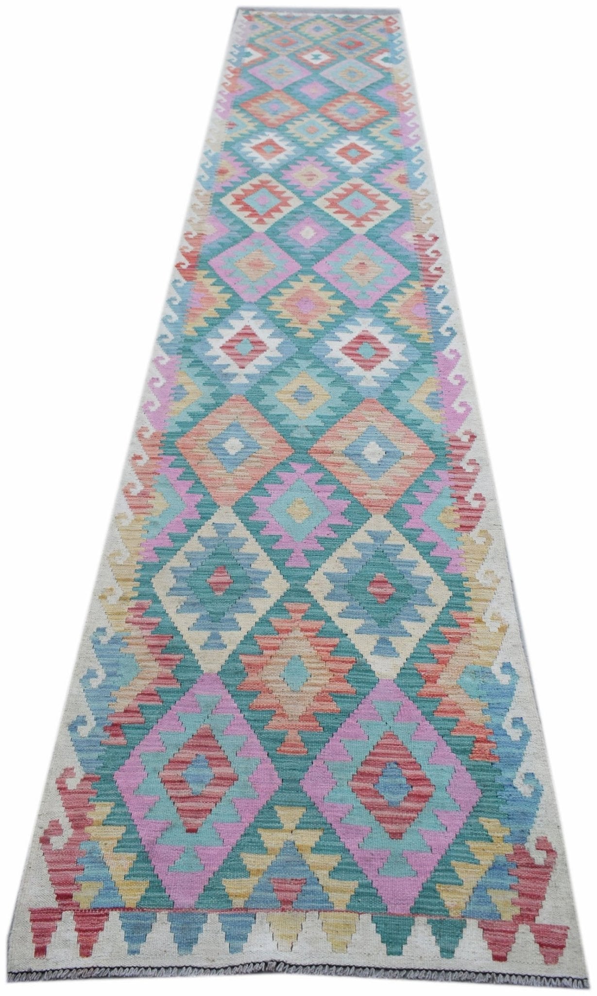 A handmade Afghan Maimana wool runner rug featuring a colorful geometric diamond pattern.