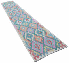 A handmade Afghan Maimana wool runner rug featuring a colorful geometric diamond pattern.
