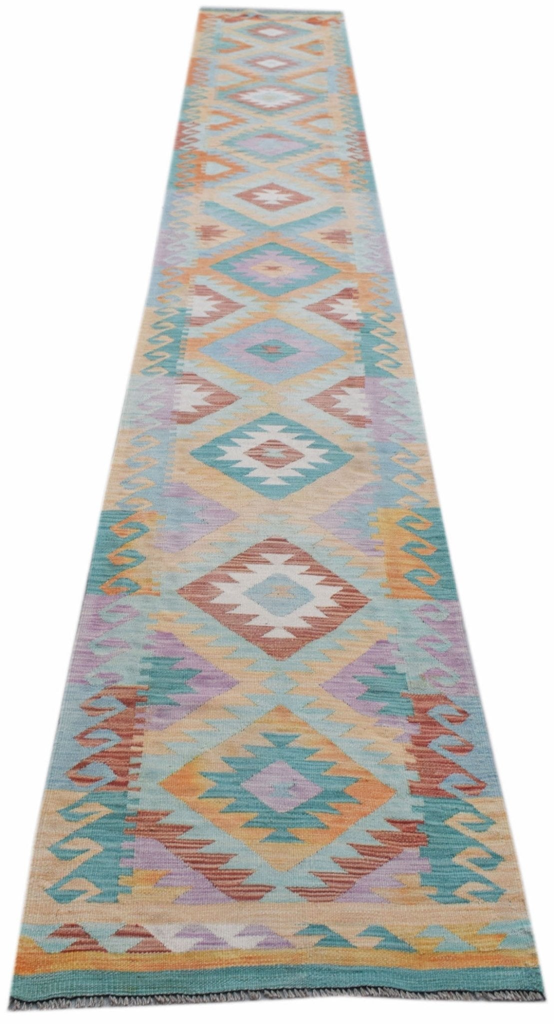 Handwoven Afghan Maimana wool runner rug featuring a colorful geometric diamond pattern.