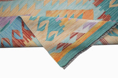 A handmade Afghan Maimana kilim runner featuring a geometric pattern in vibrant, multicolored wool.