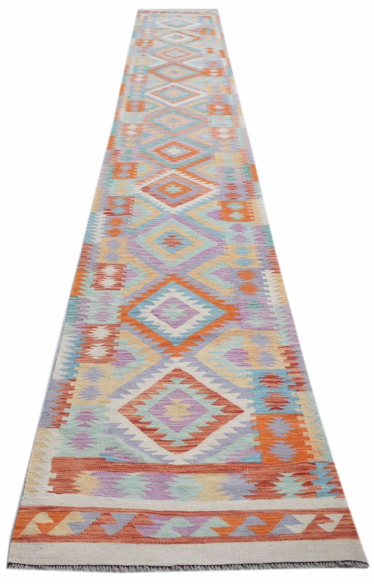A long, handmade Afghan Maimana kilim runner featuring a colorful geometric diamond pattern.