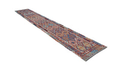 A long, handmade Afghan Maimana kilim runner featuring a vibrant geometric pattern in wool.