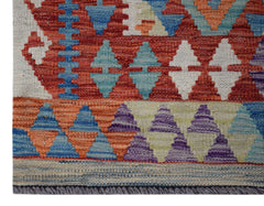 Handwoven Afghan Maimana kilim runner featuring a geometric pattern in vibrant multicolored wool.