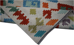 Handwoven Afghan Maimana Kilim runner featuring a colorful geometric pattern on a cream background.