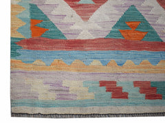 Handwoven Afghan Maimana kilim runner featuring a geometric pattern in vibrant multicolored wool.