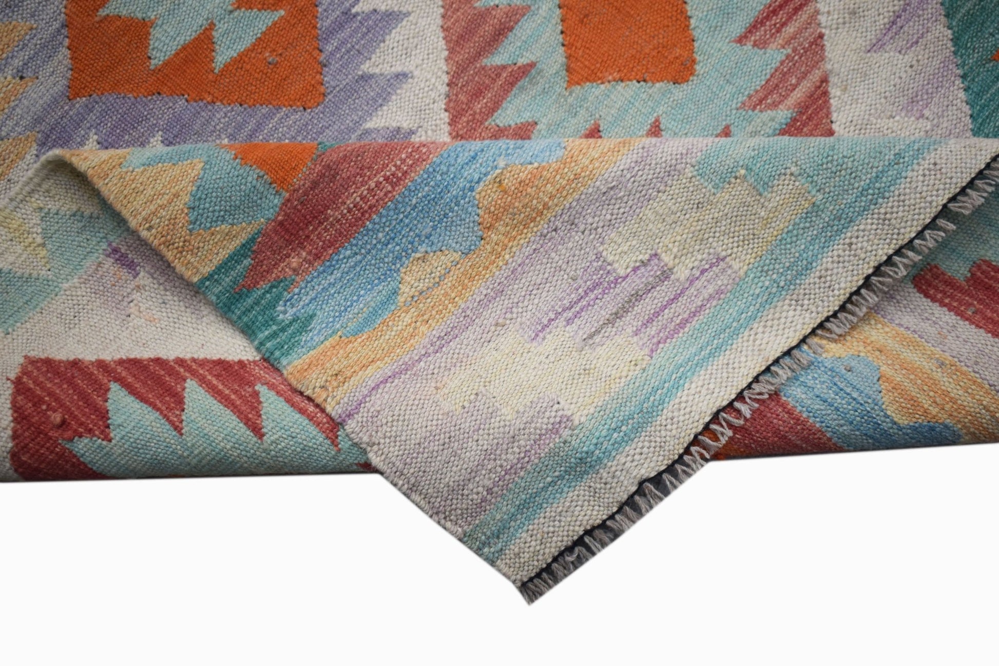 A handmade Afghan Maimana wool kilim runner featuring a colorful geometric pattern.