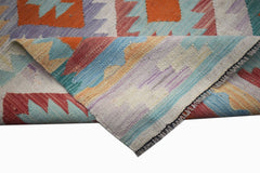 A handmade Afghan Maimana wool kilim runner featuring a colorful geometric pattern.