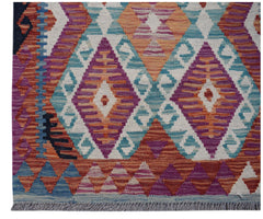 Handwoven Afghan Maimana wool runner featuring a vibrant geometric diamond pattern.
