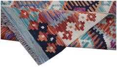 A handmade Afghan Maimana kilim runner featuring a vibrant geometric pattern in wool.