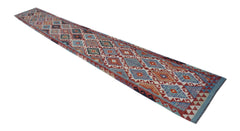A long, handmade Afghan Maimana Kilim runner featuring a vibrant geometric diamond pattern.