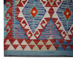 Handwoven Afghan Maimana wool runner featuring a geometric diamond pattern in red and blue tones.