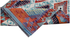 A handmade Afghan Maimana Kilim runner featuring vibrant geometric patterns in wool.