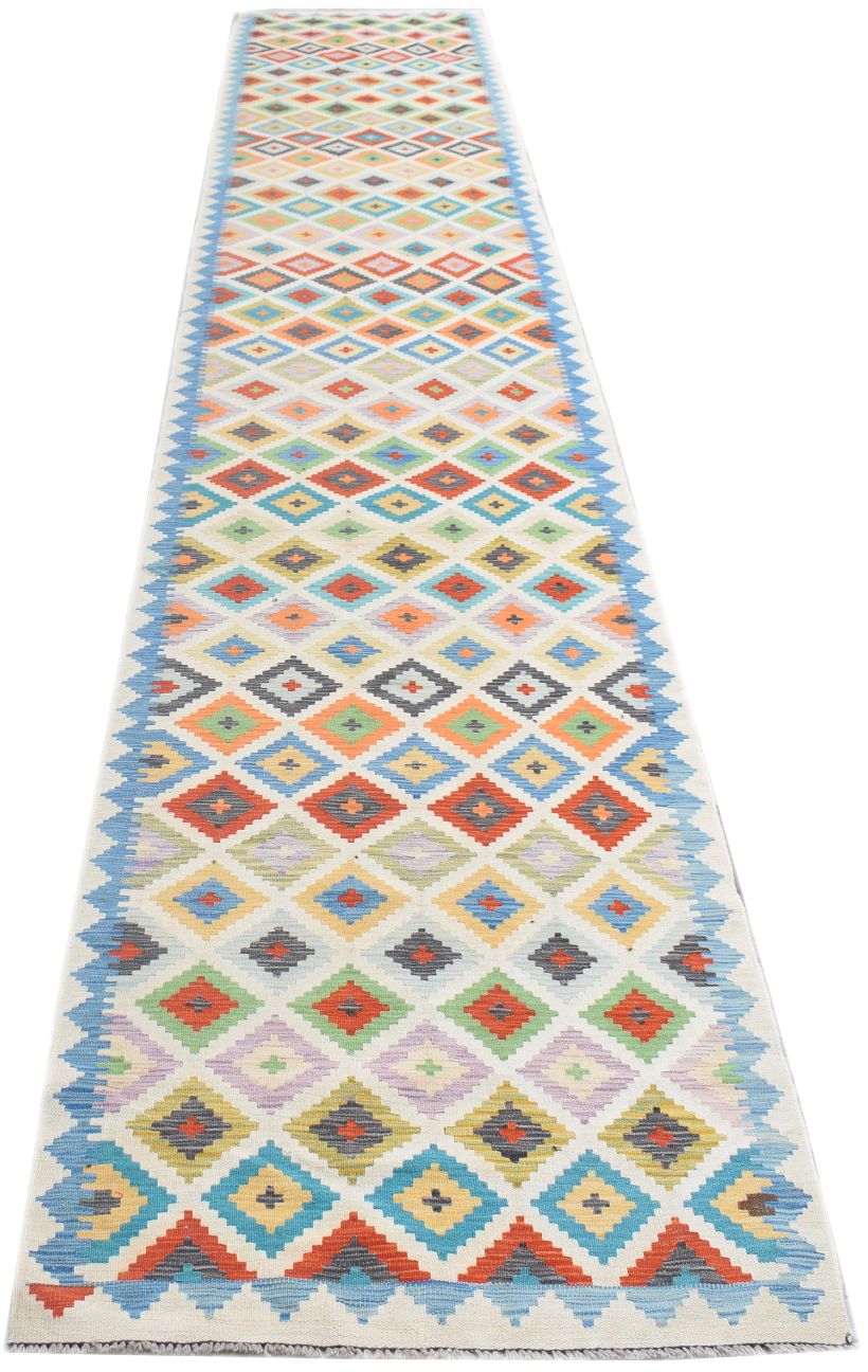 Handmade Afghan Maimana wool runner rug featuring a colorful geometric diamond pattern.
