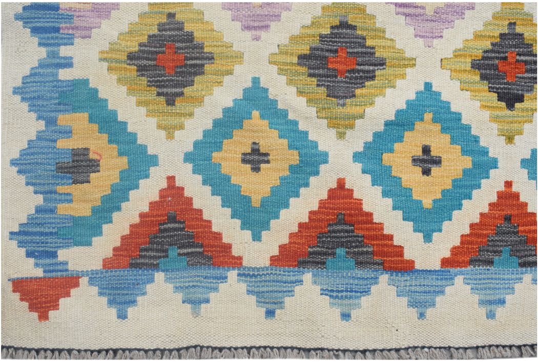 Handmade Afghan Maimana kilim runner featuring a colorful geometric diamond pattern on wool.