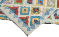 Handmade Afghan Maimana kilim runner featuring a colorful geometric pattern on a cream background.