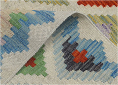A handmade Afghan Maimana kilim runner featuring a geometric pattern in vibrant multicolored wool.