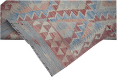 A handmade Afghan Maimana kilim runner featuring geometric patterns in blue, red, and cream.