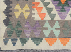 Handmade Afghan Maimana kilim runner featuring a colorful geometric pattern on a wool base.