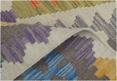 A close-up of a handmade Afghan Maimana kilim runner featuring colorful geometric patterns.