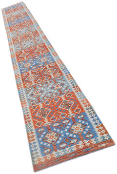 A long, handmade Afghan Maimana kilim runner featuring intricate geometric patterns in blue and orange.