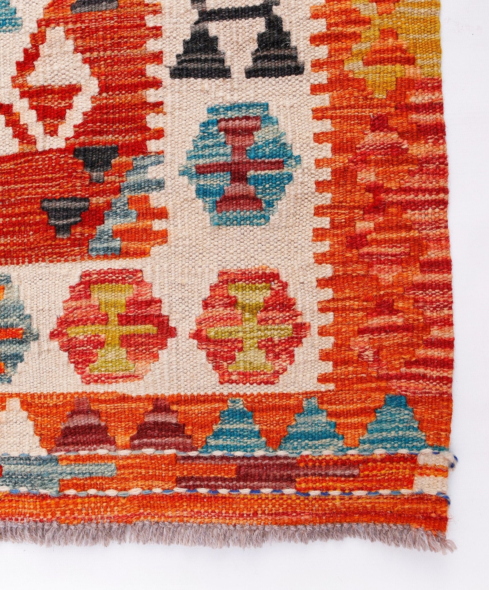 Handwoven Afghan Maimana kilim runner featuring geometric patterns in vibrant orange and blue tones.