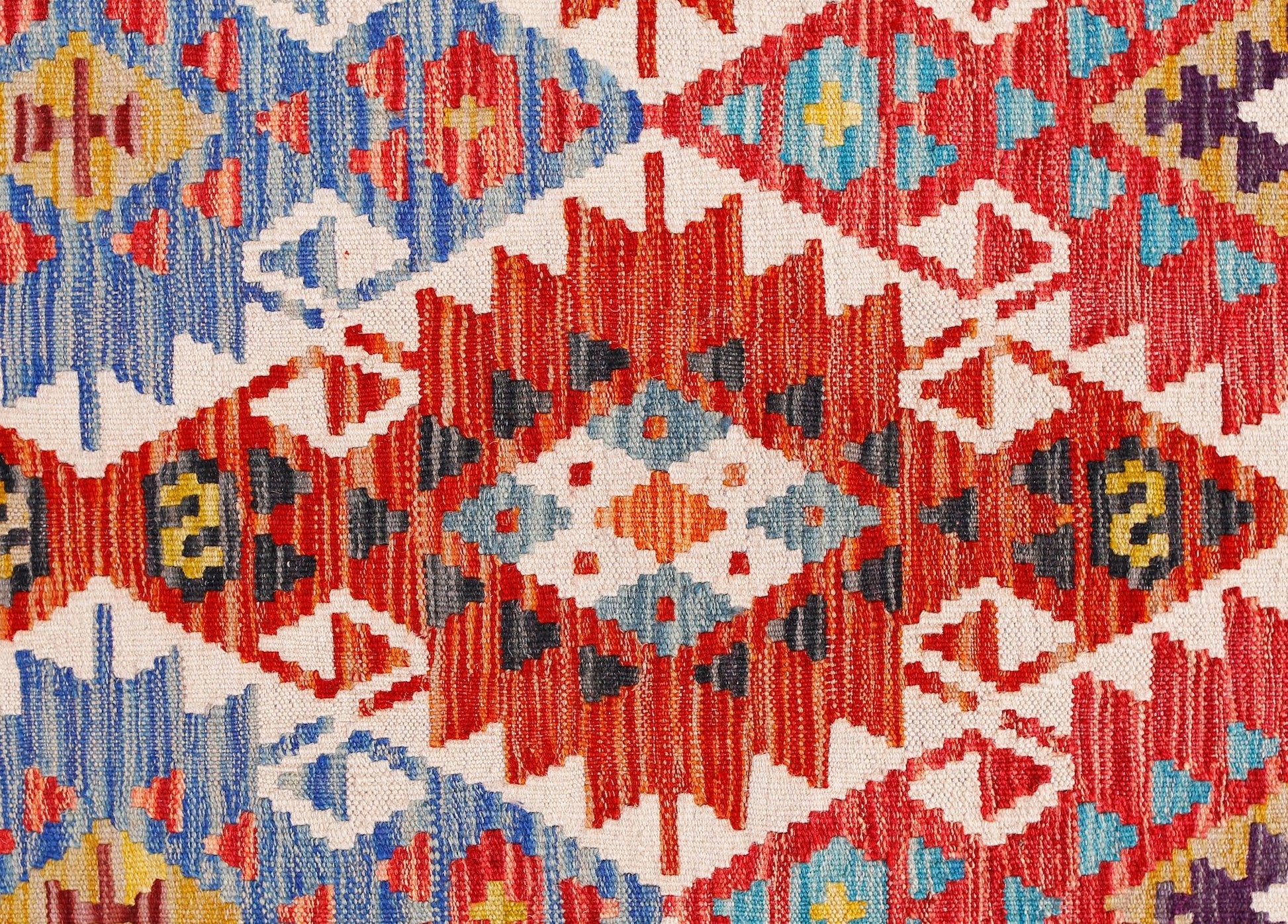 Handwoven Afghan Maimana kilim runner featuring a vibrant geometric pattern in wool.