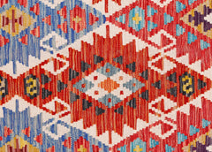 Handwoven Afghan Maimana kilim runner featuring a vibrant geometric pattern in wool.