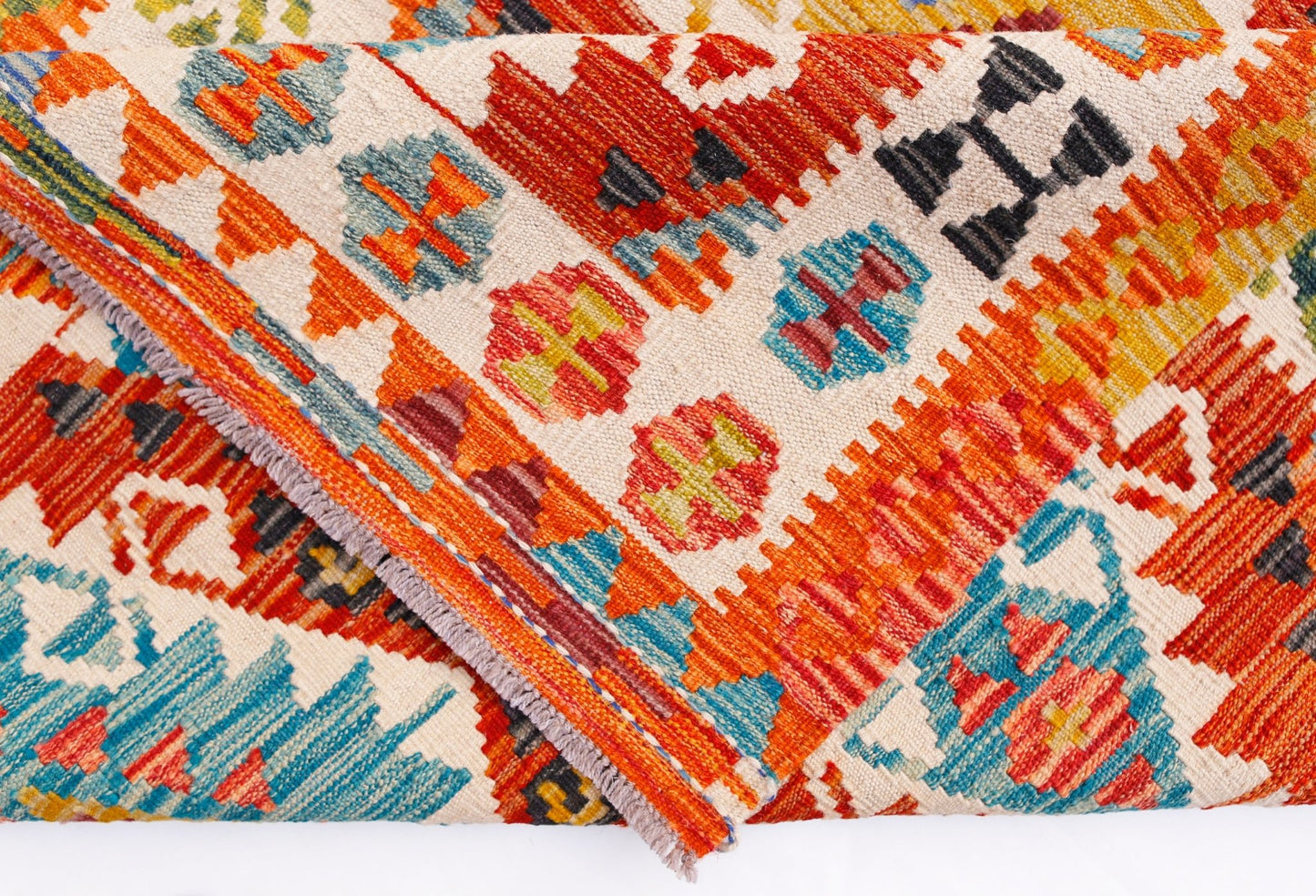 A handmade Afghan Maimana kilim runner featuring vibrant geometric patterns in wool.