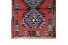 A handmade Afghan Pashm rug featuring a geometric diamond pattern in red, brown, blue, and purple.