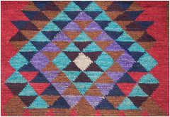 Handmade Afghan Pashm rug featuring a geometric diamond pattern in shades of red, blue, and brown.