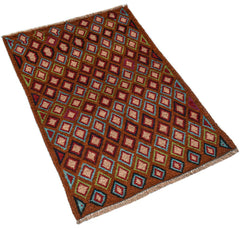 A handmade Afghan Pashm rug featuring a repeating diamond pattern in brown, blue, and red tones.