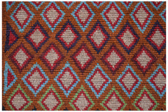 Handmade Afghan Pashm rug featuring a repeating diamond pattern in shades of red, blue, and brown.
