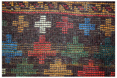 Handmade Afghan Pashm rug featuring a dark brown wool base with colorful geometric cross patterns.