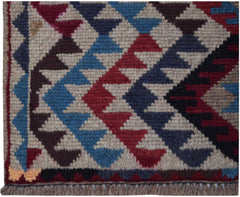 Handmade Afghan Pashm rug featuring a geometric diamond pattern in red, blue, and brown wool.