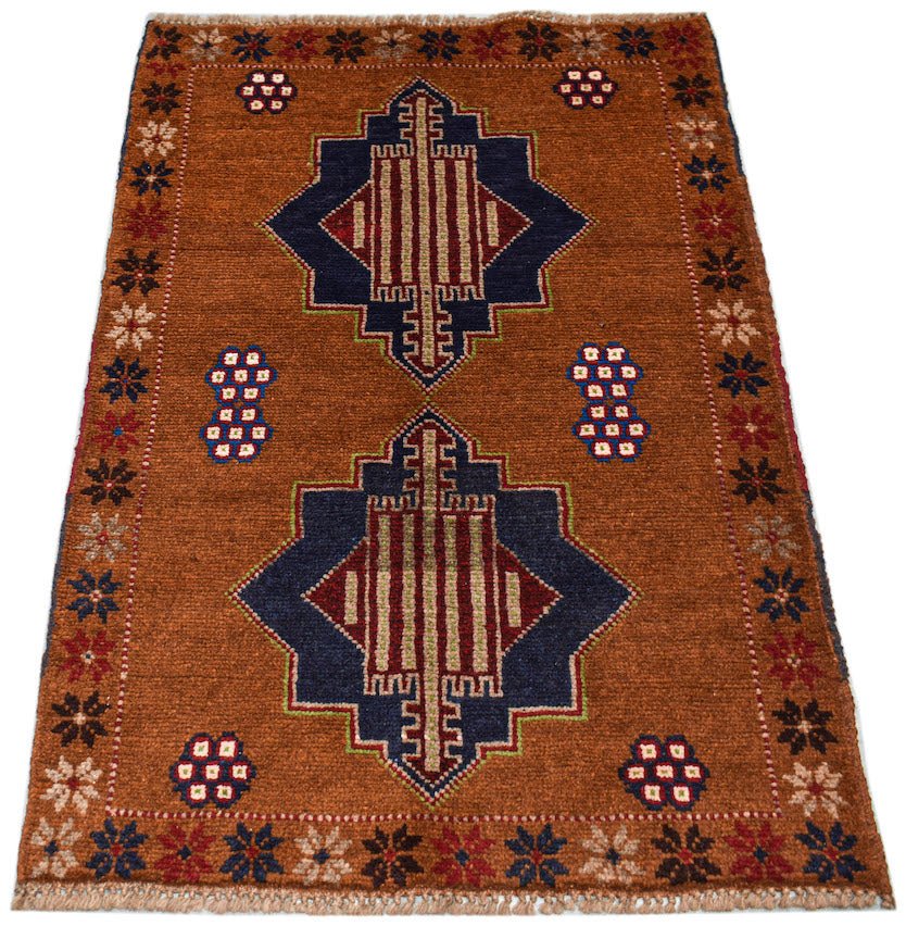 Handmade Afghan Pashm rug featuring two dark blue geometric medallions on a rust-colored field.