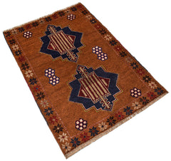 Handmade Afghan Pashm rug featuring two dark blue geometric medallions on a brown wool field.