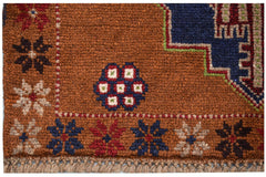 Handmade Afghan Pashm rug featuring a brown field with geometric floral motifs and a fringed edge.