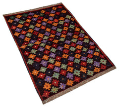 Handmade Afghan Pashm rug featuring a repeating geometric floral pattern in vibrant colors.