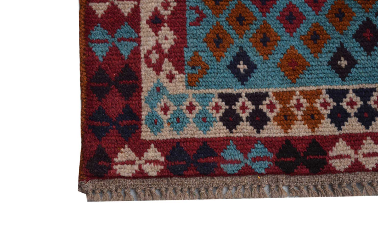 A handmade Afghan Pashm rug featuring a geometric pattern in red, blue, brown, and ivory tones.
