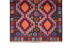 Handmade Afghan Pashm rug featuring geometric diamond patterns in vibrant colors on a dark background.