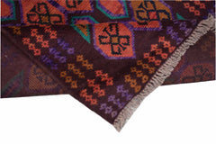 A handmade Afghan Pashm rug featuring geometric patterns in dark brown, orange, and purple.