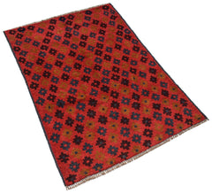 Handmade Afghan Pashm rug featuring a repeating geometric floral pattern in red, blue, and brown.